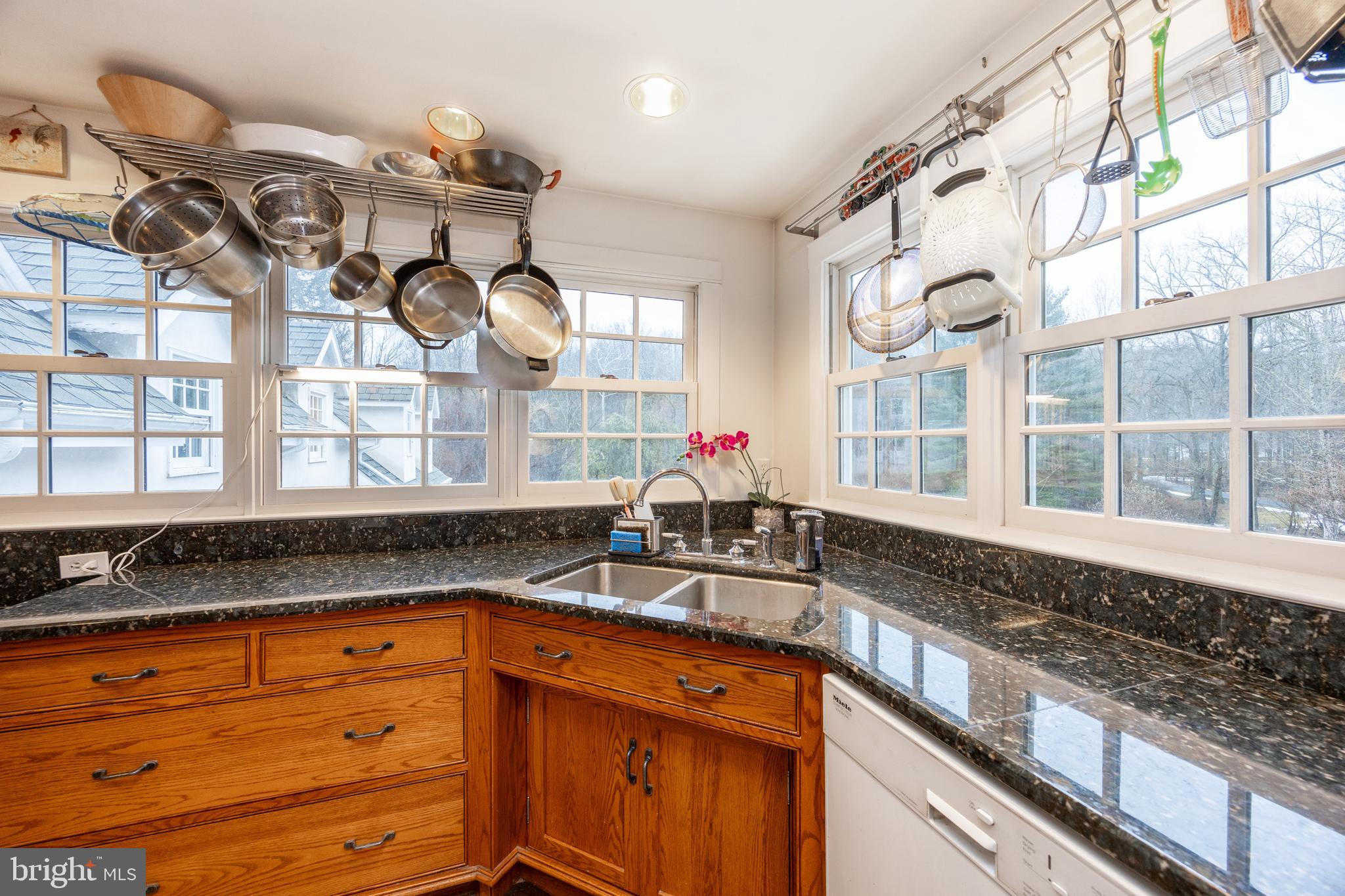 580 Reeds Road Downingtown, PA 19335 - Photo 42 of 82 a kitchen with stainless steel appliances granite countertop a sink a stove and a granite counter tops with wooden floors