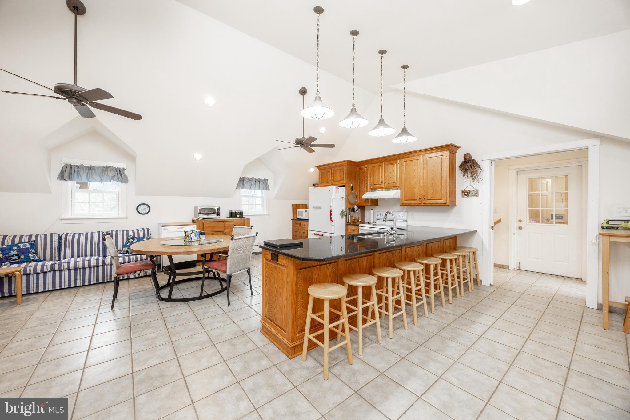 580 Reeds Road Downingtown, PA 19335 - Photo 52 of 82 a large living room with kitchen island granite countertop lots of white furniture