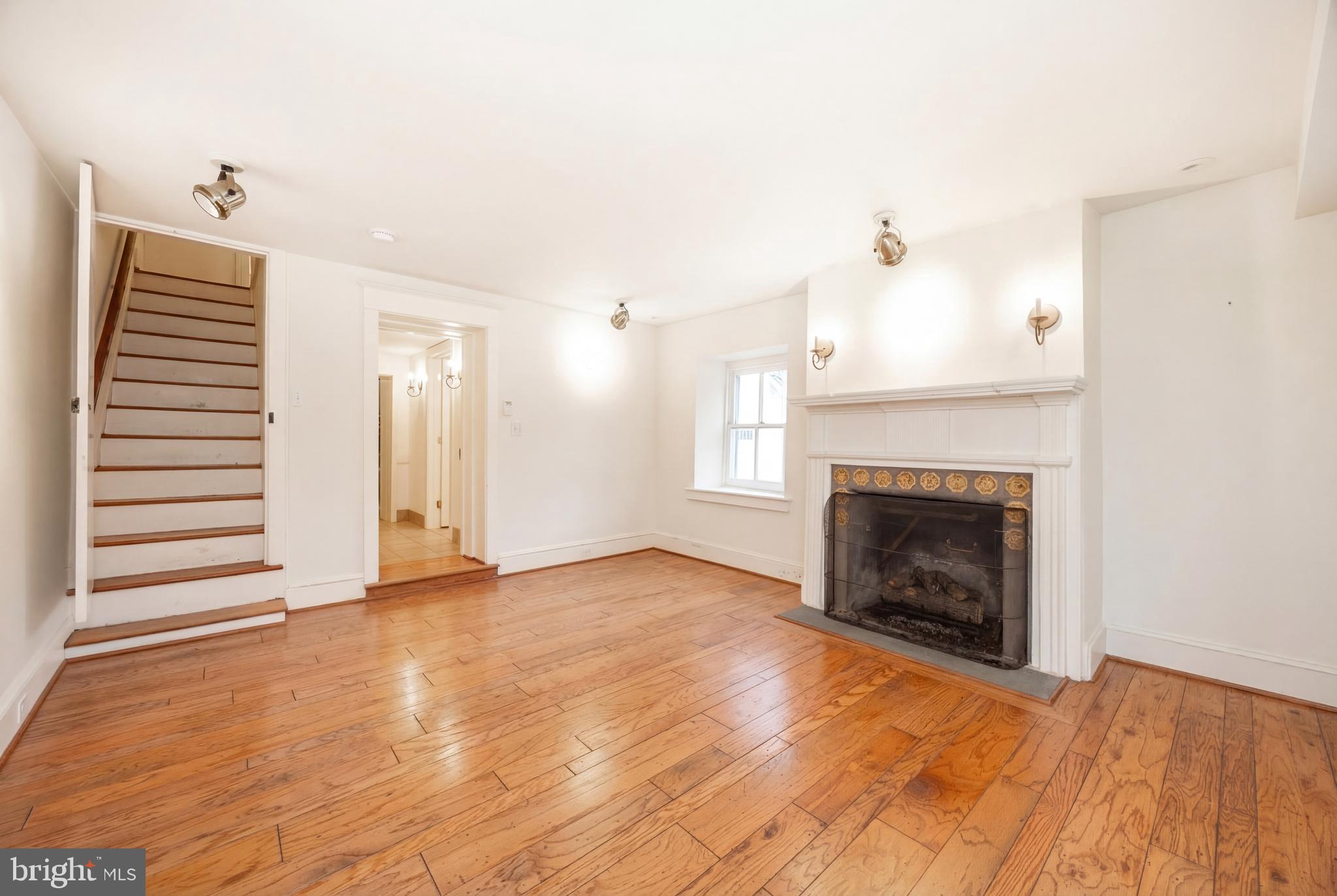 580 Reeds Road Downingtown, PA 19335 - Photo 10 of 82 a view of an empty room with wooden floor fireplace and a window