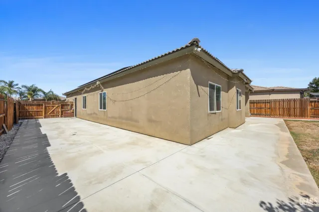 a view of a house with a wooden fence