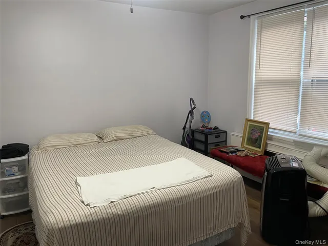 a bedroom with a bed and windows