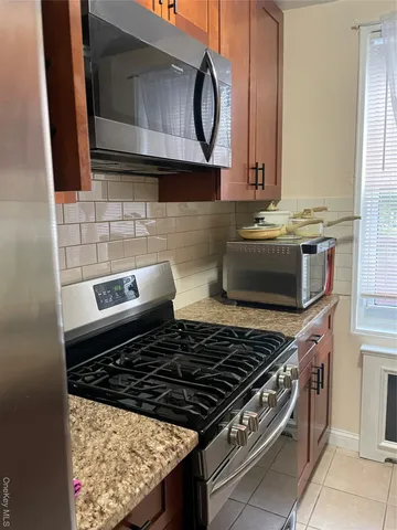 a stove top oven sitting inside of a kitchen