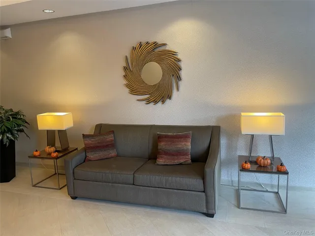 a living room with furniture and a lamp