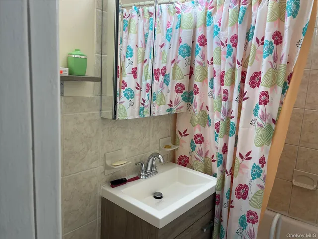 a bathroom with a sink and a curtain