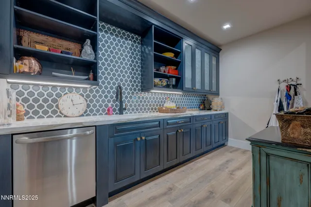 a kitchen with stainless steel appliances granite countertop a sink and cabinets