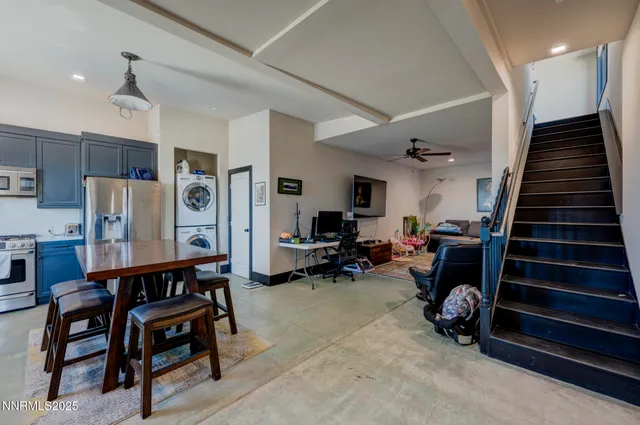 a kitchen with a table chairs refrigerator and microwave