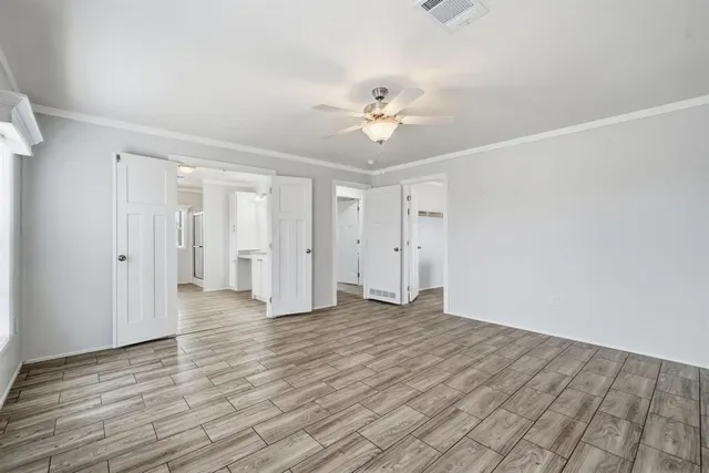 a view of an empty room with wooden floor