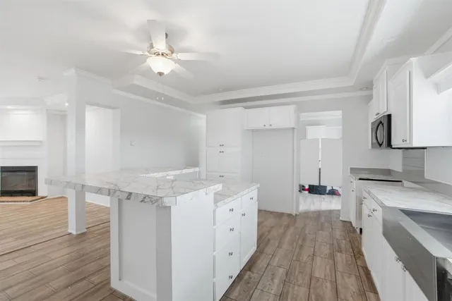 a kitchen with a sink dishwasher a stove and a refrigerator with wooden floor