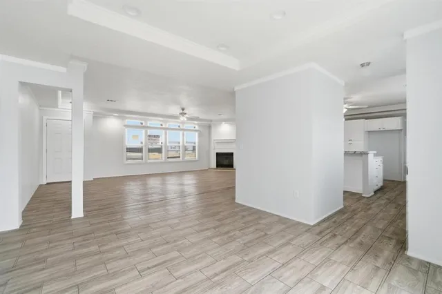 a view of a kitchen with wooden floor and a refrigerator