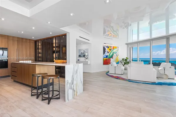 a living room with furniture and kitchen view