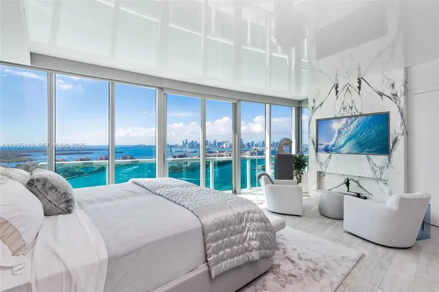 a large bedroom with a large bed and a large window