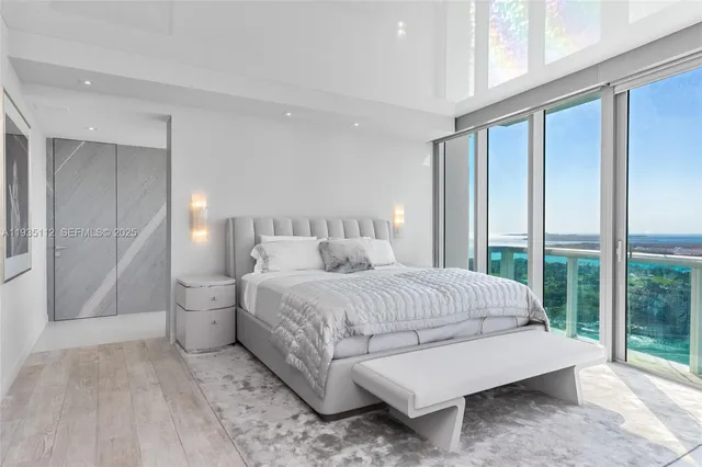 a spacious bedroom with a bed and large window