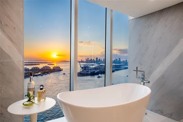 a view of a bathroom with tub and sink