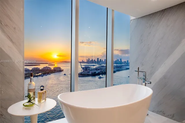 a view of a bathroom with tub and sink