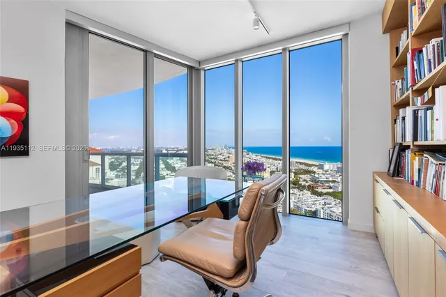 a living room with furniture a bookshelf and a book shelf