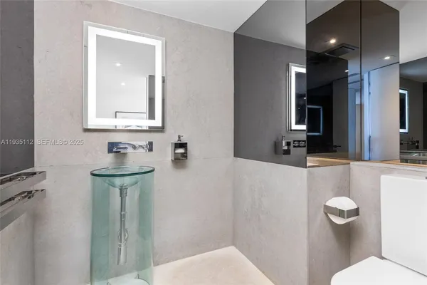 a bathroom with a toilet sink and mirror