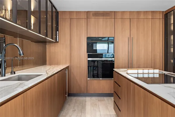a kitchen with stainless steel appliances granite countertop a sink stove and cabinets