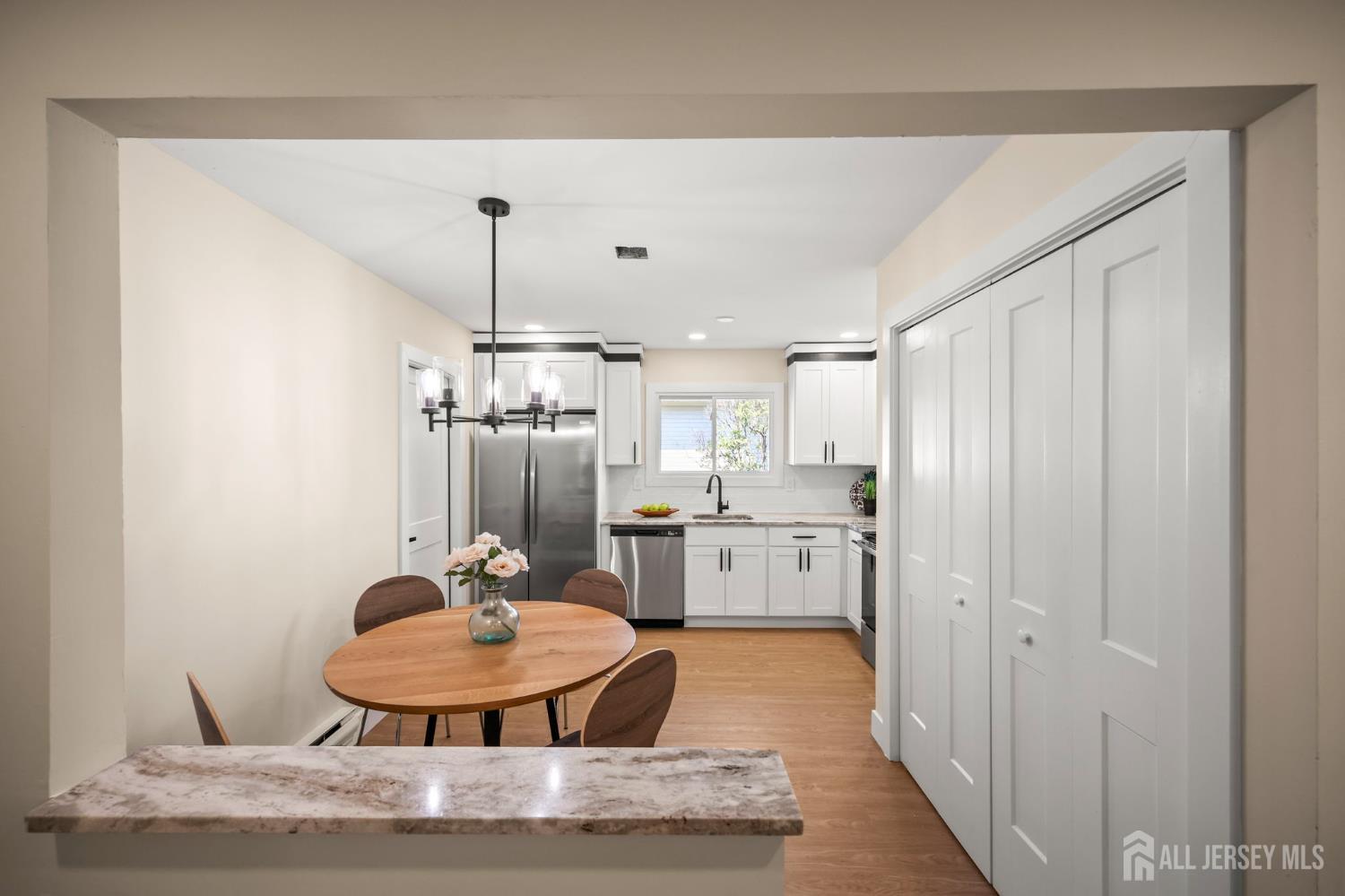 701 Croydon Road, Unit A Monroe Township, NJ 08831 - Photo 9 of 34 a room with stainless steel appliances kitchen island a table and chairs in it