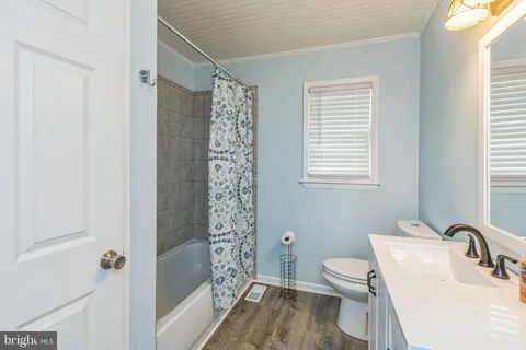 a bathroom with a toilet a sink and shower