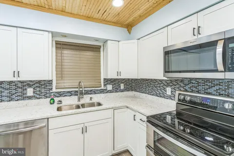 a kitchen with a sink stove and microwave