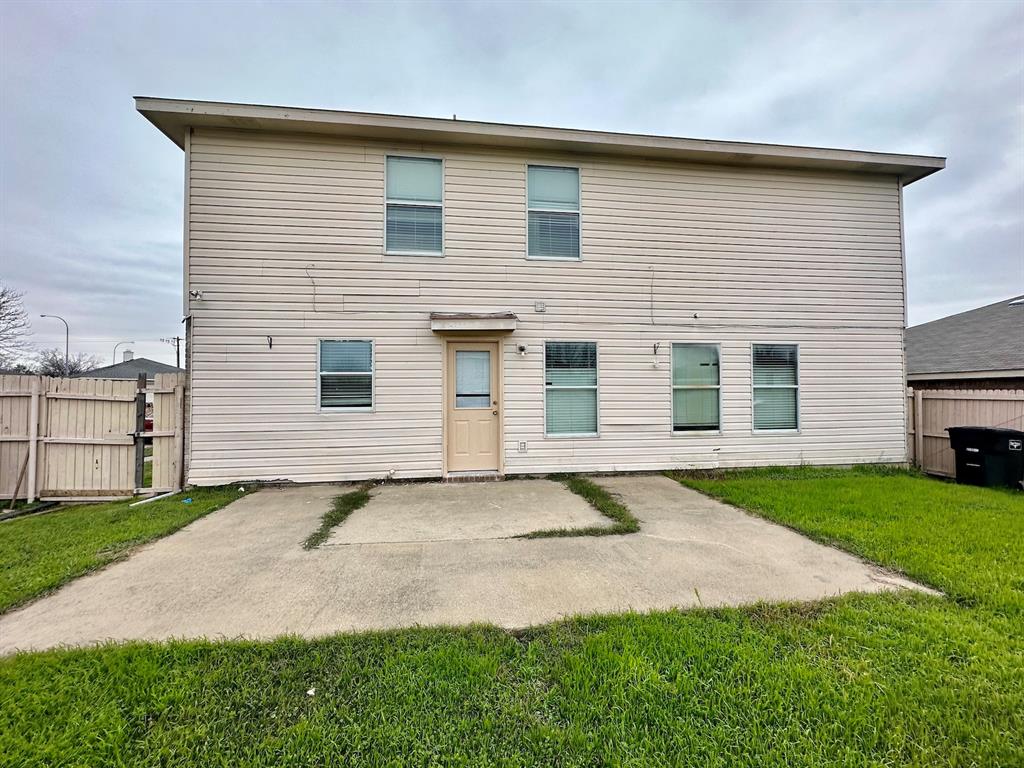 5437 New Castleton Lane Fort Worth, TX 76135 - Photo 15 of 16 a front view of a house with a yard and garage