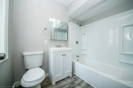 a bathroom with a toilet a sink and bathtub