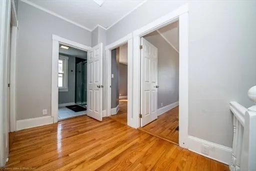 wooden floor with a bathroom