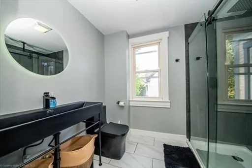 a bathroom with a sink mirror vanity and toilet