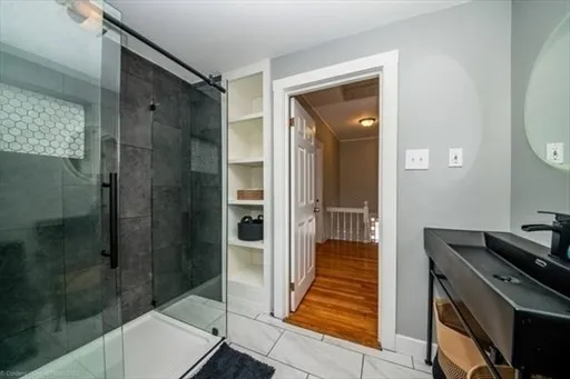 a bathroom with a shower and a mirror