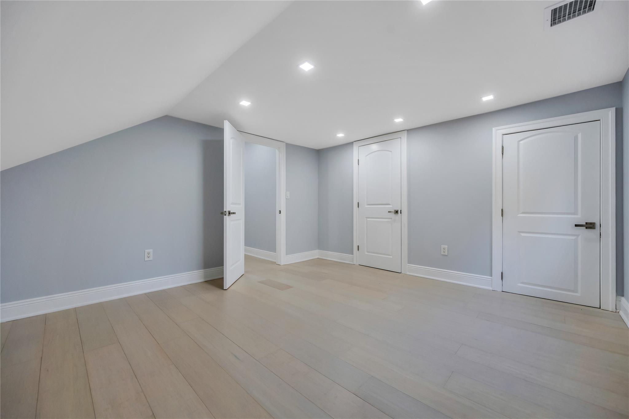503 Bayville Road Locust Valley, NY 11560 - Photo 21 of 26 Additional living space featuring light hardwood / wood-style floors and lofted ceiling