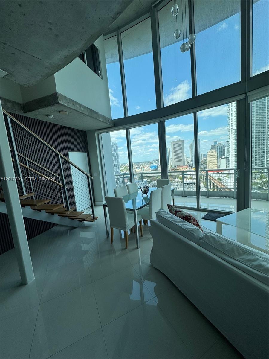 690 Southwest 1st Court, Unit 2301 Miami, FL 33130 - Photo 11 of 26 a room with gym equipment and a large window