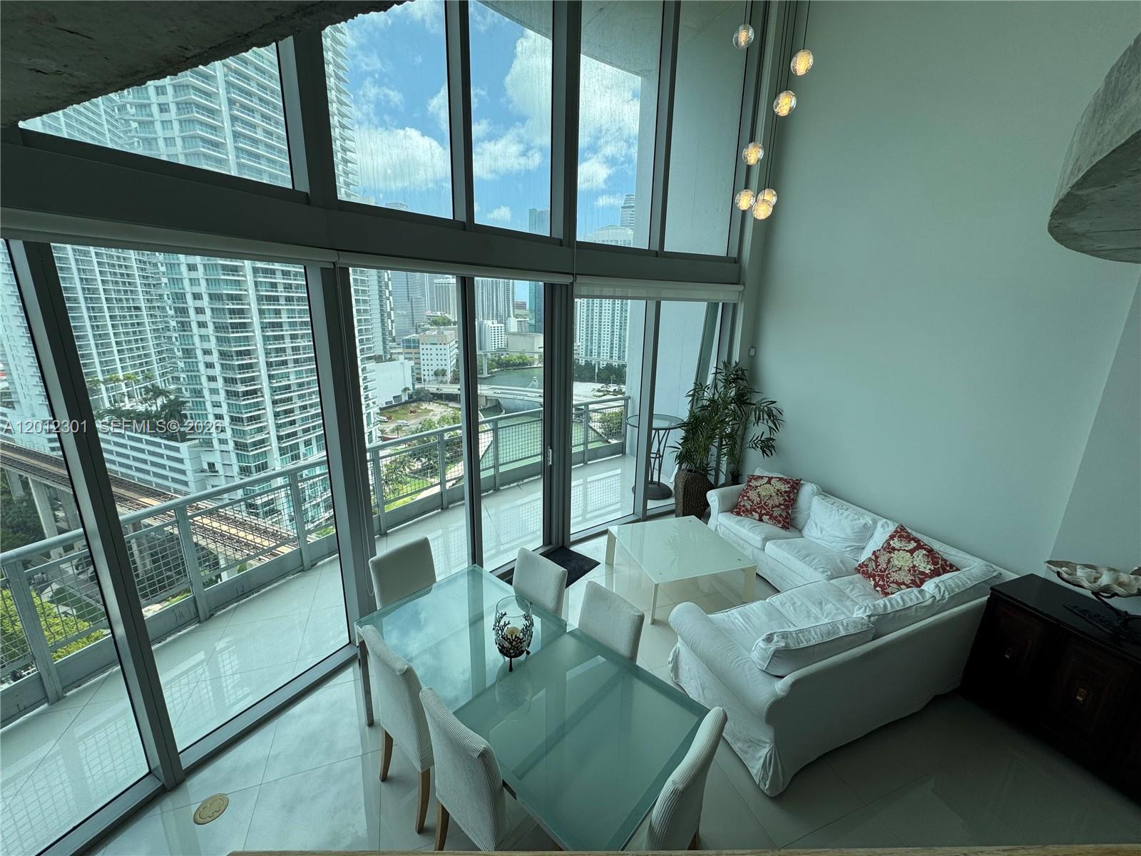 690 Southwest 1st Court, Unit 2301 Miami, FL 33130 - Photo 13 of 26 a living room with furniture and a window