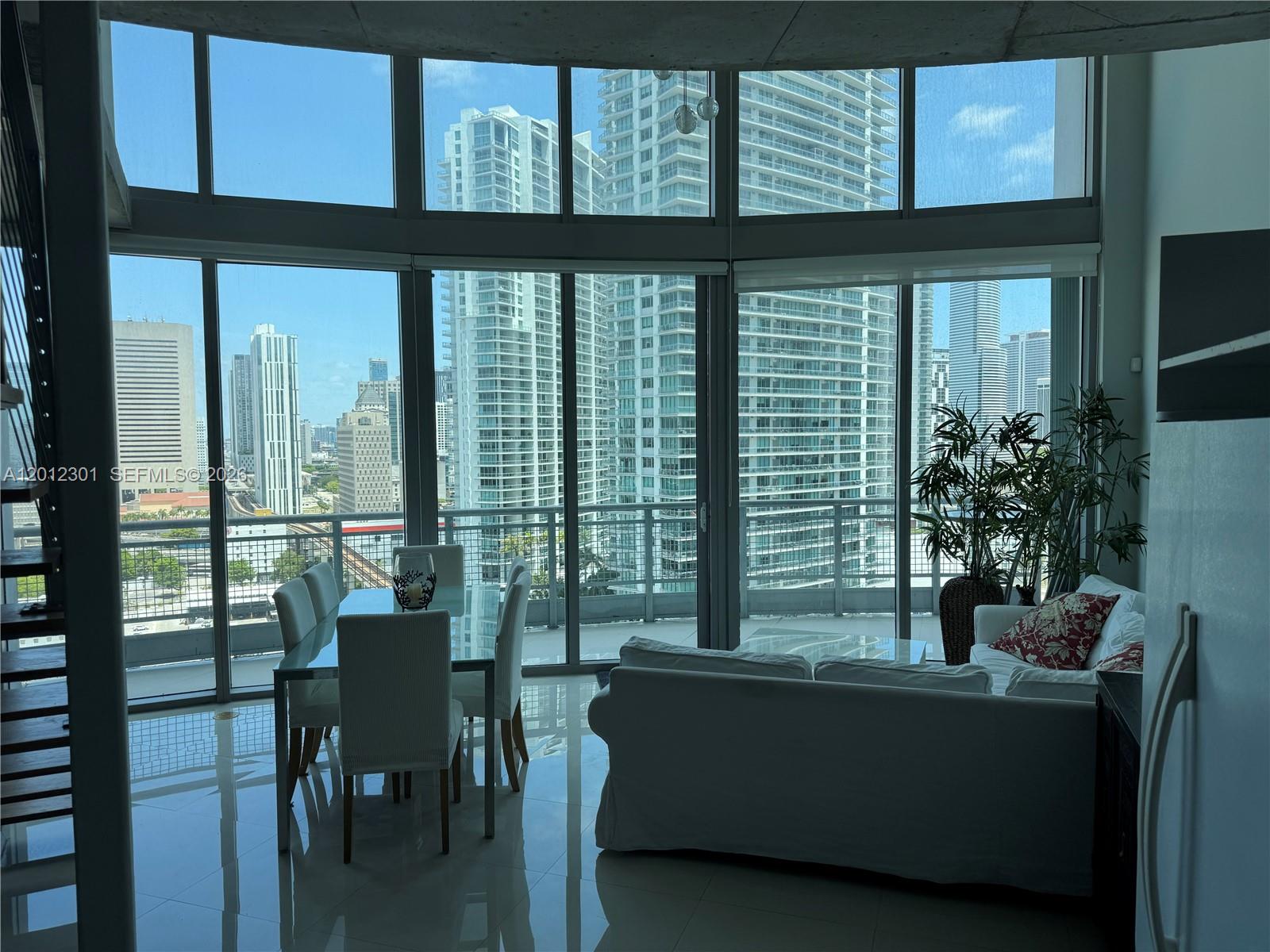 690 Southwest 1st Court, Unit 2301 Miami, FL 33130 - Photo 16 of 26 a living room with furniture and a potted plant