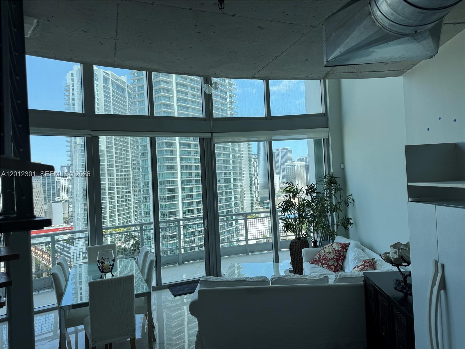 690 Southwest 1st Court, Unit 2301 Miami, FL 33130 - Photo 17 of 26 a living room with furniture and a potted plant