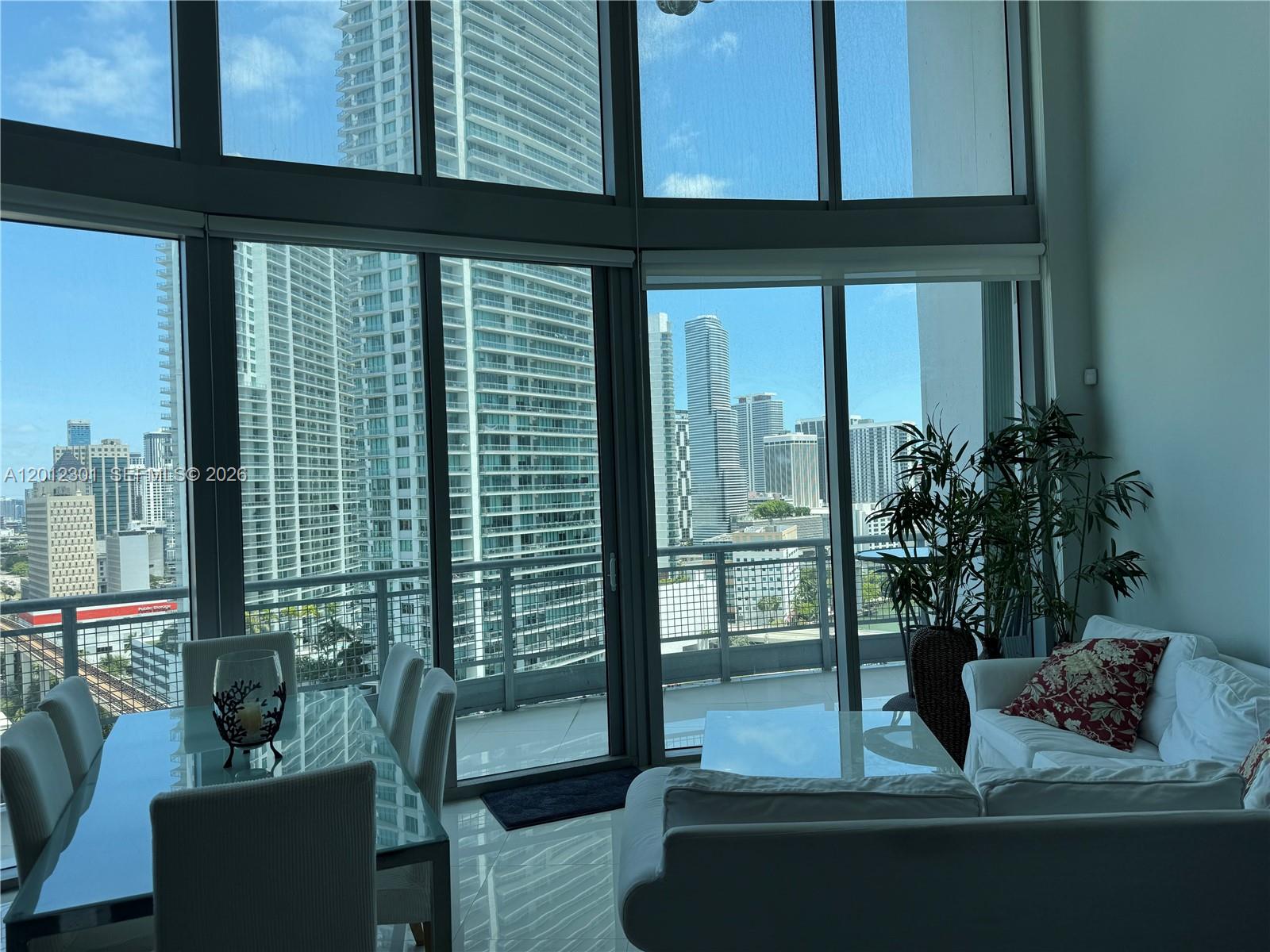 690 Southwest 1st Court, Unit 2301 Miami, FL 33130 - Photo 18 of 26 a view of living room filled with furniture and a potted plant