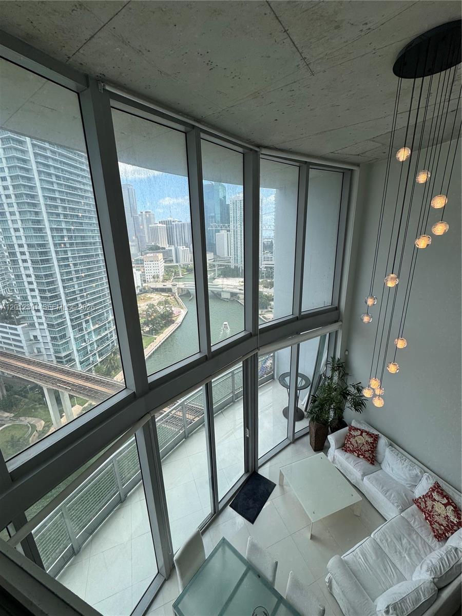 690 Southwest 1st Court, Unit 2301 Miami, FL 33130 - Photo 23 of 26 a living room with furniture and a large window