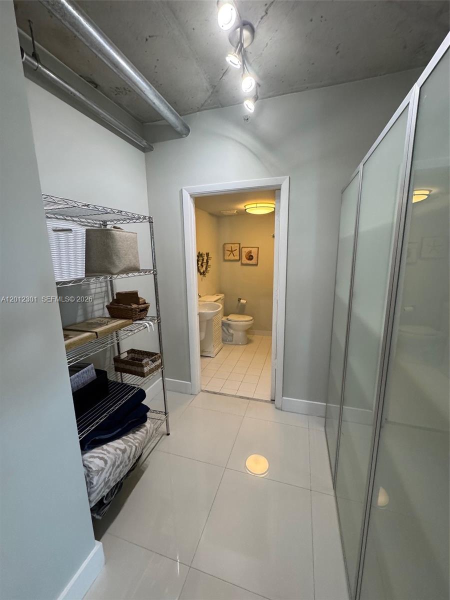 690 Southwest 1st Court, Unit 2301 Miami, FL 33130 - Photo 9 of 26 a bathroom with a sink and a mirror