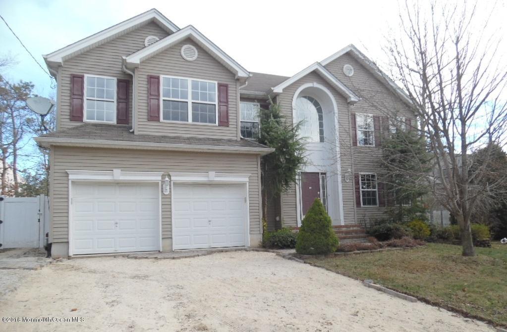 116 Lanyard Road Manahawkin, NJ 08050 - Photo 1 of 11 a front view of a house with a yard and garage