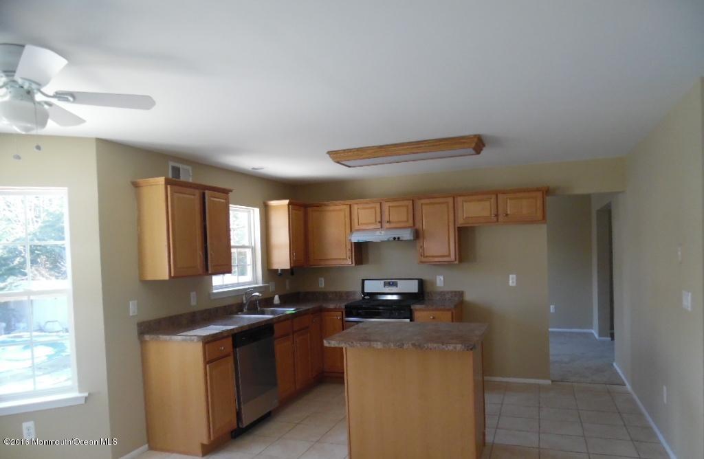 116 Lanyard Road Manahawkin, NJ 08050 - Photo 2 of 11 a kitchen with stainless steel appliances granite countertop a stove a sink and a refrigerator