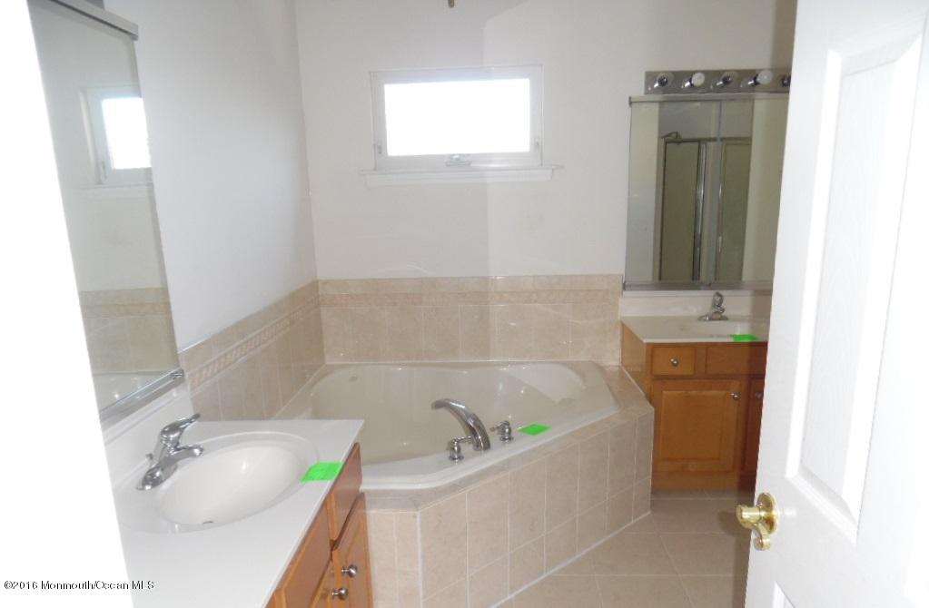 116 Lanyard Road Manahawkin, NJ 08050 - Photo 8 of 11 a bathroom with a tub sink and mirror