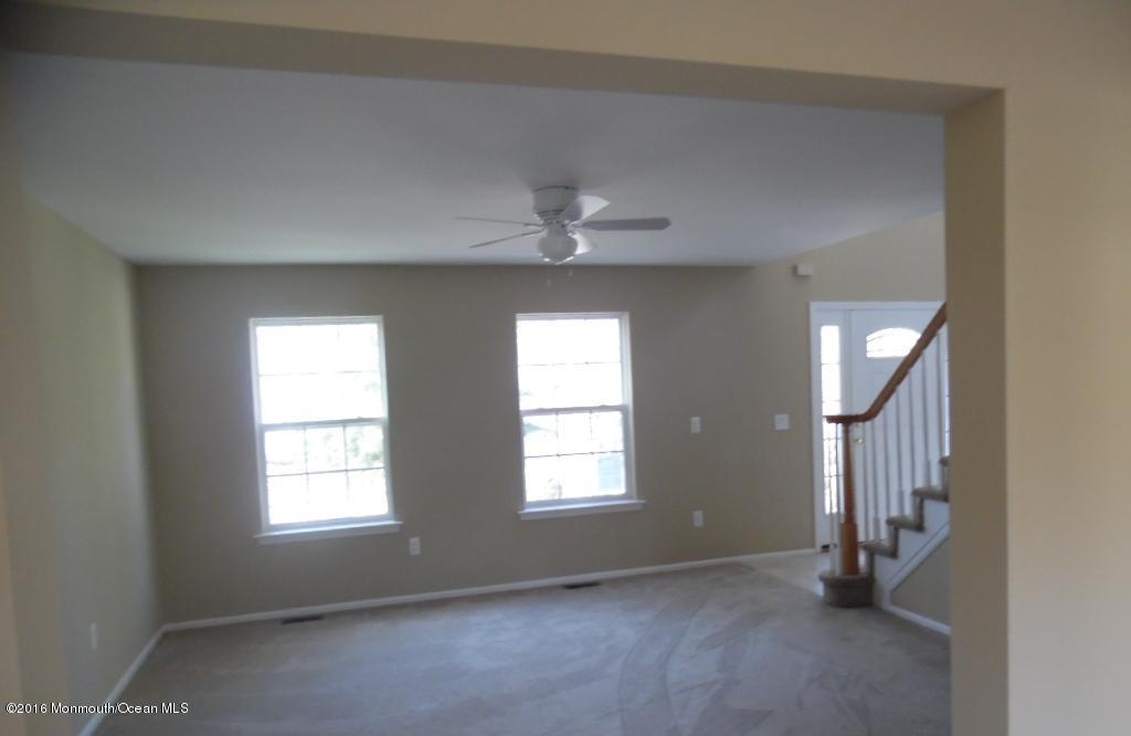 116 Lanyard Road Manahawkin, NJ 08050 - Photo 10 of 11 an empty room with windows and fan