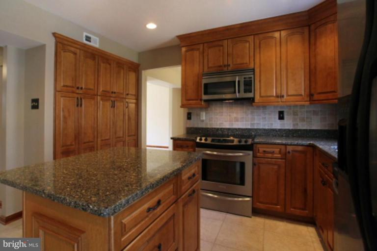 17915 Marshall Mill Road Hampstead, MD 21074 - Photo 3 of 30 a kitchen with stainless steel appliances granite countertop a stove a sink and a microwave