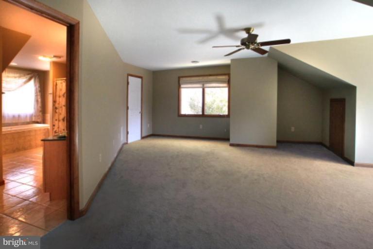 17915 Marshall Mill Road Hampstead, MD 21074 - Photo 22 of 30 a view of a livingroom with a ceiling fan and window