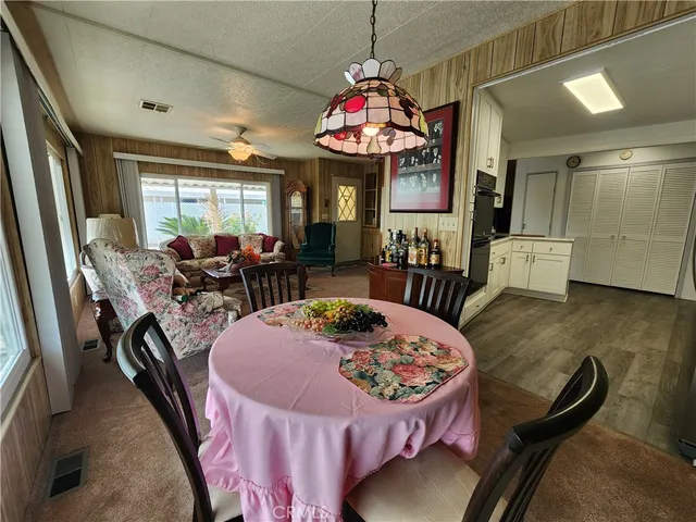 a kitchen with white cabinets and refrigerator