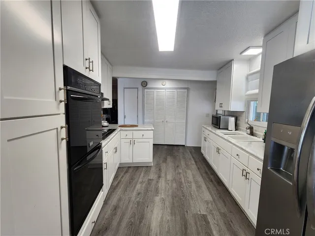 a kitchen with stainless steel appliances granite countertop a stove a refrigerator and a granite counter tops