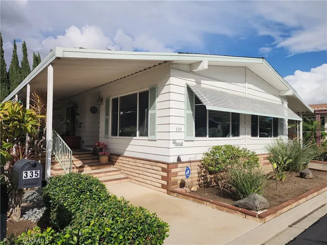 a view of a house with potted plants