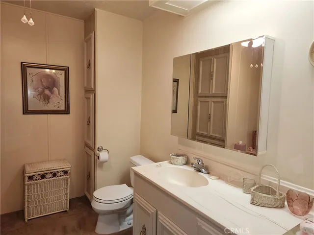 a bathroom with a double vanity sink mirror and toilet