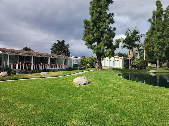a view of a lake with houses in the back