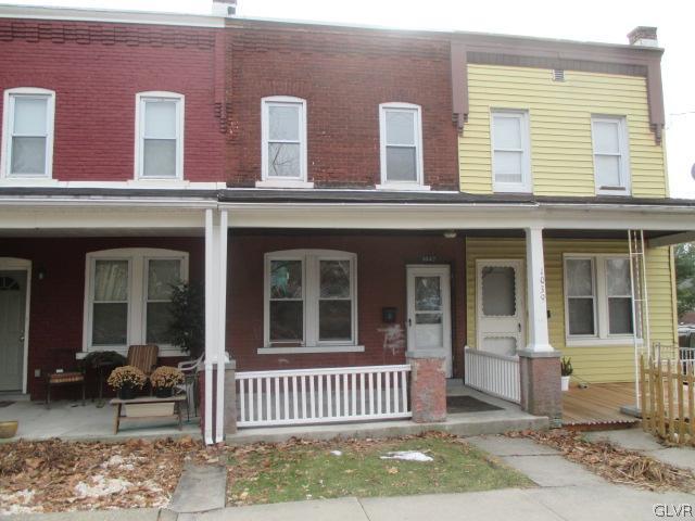 1037 Spring Street Bethlehem, PA 18018 - Photo 1 of 11 front view of a brick house with a small yard