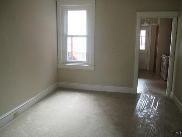 1037 Spring Street Bethlehem, PA 18018 - Photo 3 of 11 an empty room with wooden floor and windows